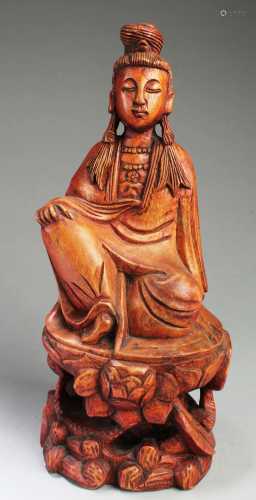 A Carved Wood Deity Statue