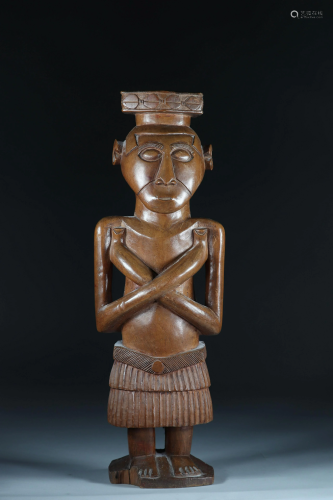 Kuba character statue with crossed arms