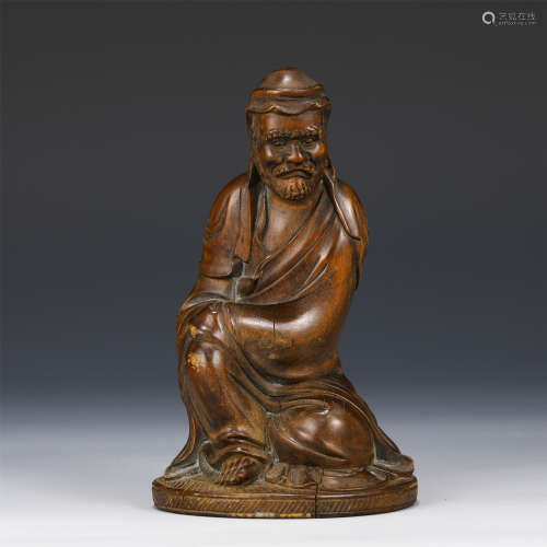 A CHINESE CARVED WOOD FIGURE DECORATION