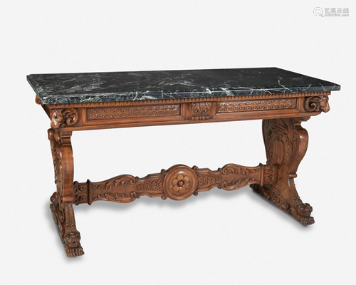 A Renaissance Revival carved walnut library table