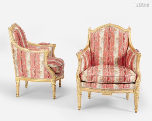 A pair of Louis XVI-style carved giltwood armchairs