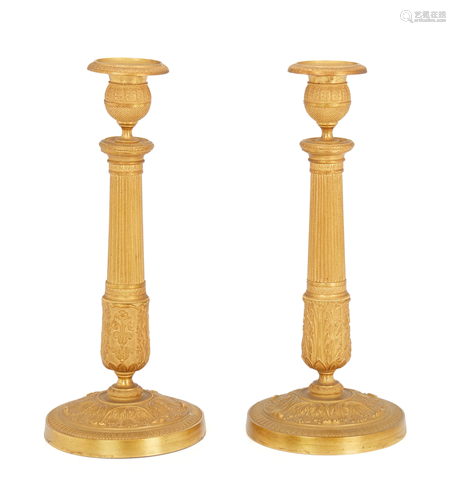 A pair of French Empire gilt-bronze candlesticks