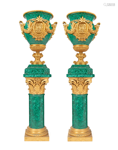 A pair of monumental malachite urns on stands