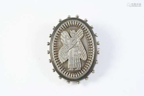 A 19TH CENTURY ASSYRIAN REVIVAL SILVER BROOCH with locket co...