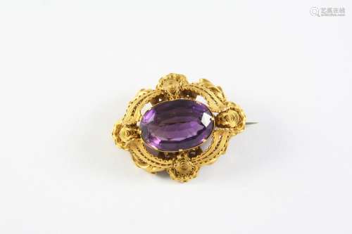 A VICTORIAN GOLD AND AMETHYST BROOCH the oval-shaped amethys...