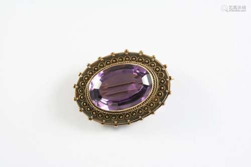 A VICTORIAN AMETHYST AND GOLD BROOCH the oval-shaped amethys...