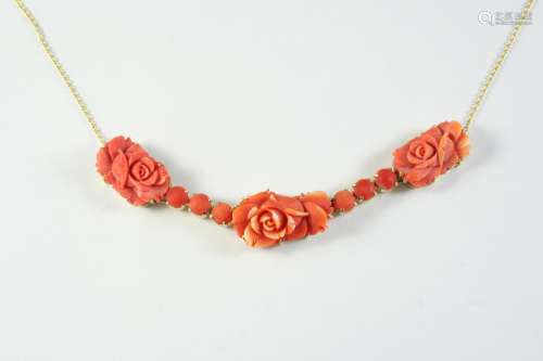 A CARVED CORAL NECKLET formed with three carved coral flower...