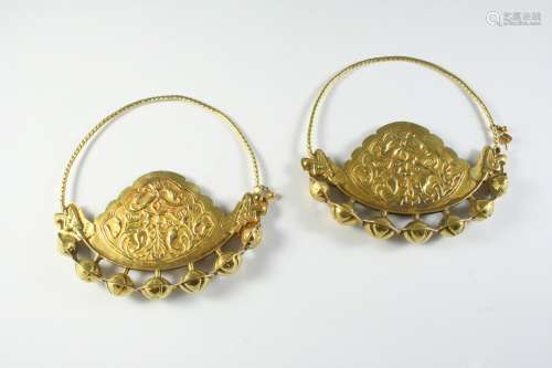 A PAIR OF EASTERN GOLD EARRINGS each with embossed Eastern i...