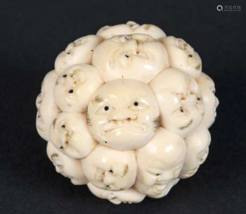 JAPANESE IVORY BALL - FACES a late 19thc or early 20thc Meij...