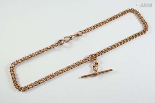 A 9CT GOLD CURB LINK WATCH CHAIN suspending a 9ct gold 't' b...