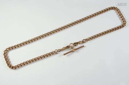 A 9CT GOLD CURB LINK WATCH CHAIN suspending a 9ct gold 't' b...