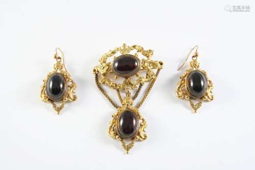 A VICTORIAN GARNET AND GOLD BROOCH the gold openwork foliate...