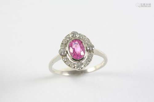 A PINK SAPPHIRE AND DIAMOND CLUSTER RING the oval-shaped pin...