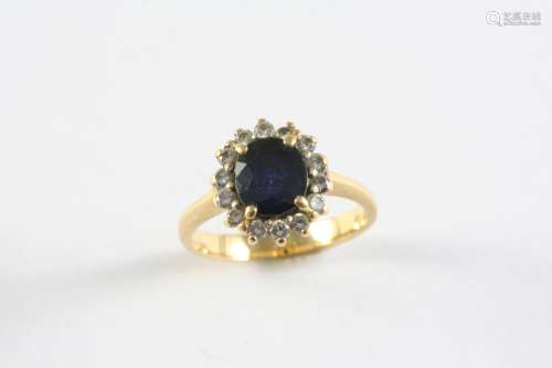 A SAPPHIRE AND DIAMOND CLUSTER RING the oval-shaped sapphire...