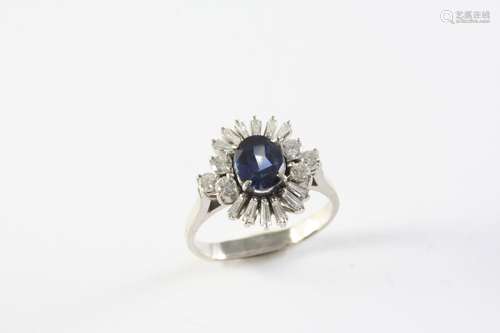 A SAPPHIRE AND DIAMOND CLUSTER RING the oval-shaped sapphire...