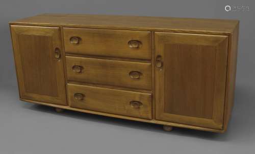 ERCOL SIDEBOARD a vintage light elm sideboard, with three ce...
