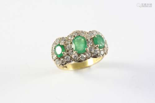 AN EMERALD AND DIAMOND TRIPLE CLUSTER RING mounted with thre...