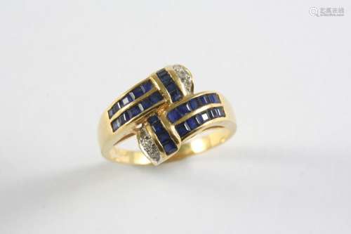 A SAPPHIRE AND DIAMOND CROSS-OVER RING mounted with calibre-...