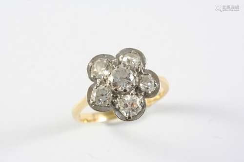 A DIAMOND CLUSTER RING the flowerhead design is set with cir...