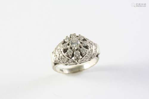 A DIAMOND CLUSTER RING set overall with circular-cut diamond...
