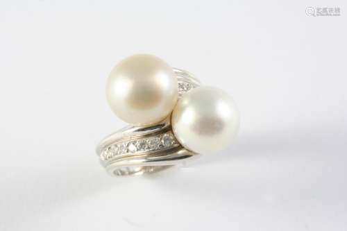 A CULTURED PEARL AND DIAMOND CROSS-OVER RING the cultured pe...