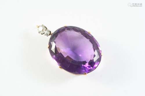 AN AMETHYST AND DIAMOND PENDANT the large oval-shaped amethy...