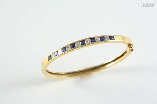 A GOLD, SAPPHIRE AND DIAMOND HALF HINGED BANGLE the 18ct gol...