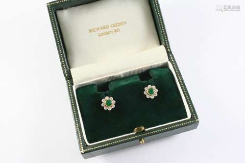 A PAIR OF EMERALD AND DIAMOND CLUSTER STUD EARRINGS of flowe...