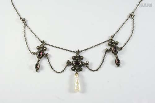 AN ARTS AND CRAFTS GARNET AND SILVER NECKLACE formed with th...