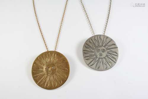 A 9CT GOLD AND DIAMOND SUNBURST PENDANT of circular form, th...