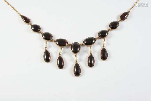 A GARNET AND GOLD DROP NECKLACE the gold chain necklace moun...