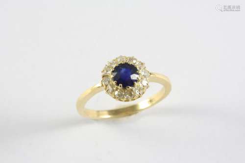 A SAPPHIRE AND DIAMOND CLUSTER RING the circular-cut sapphir...