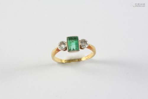 AN EMERALD AND DIAMOND THREE STONE RING the rectangular-shap...