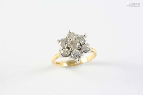 A DIAMOND CLUSTER RING the flowerhead design is set with sev...