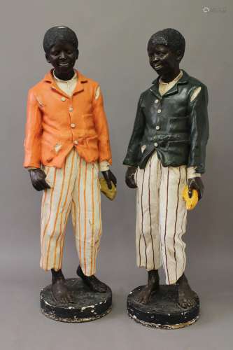 A PAIR OF CAST COMPOSITION 'BLACKAMORE' FIGURES, each of a y...