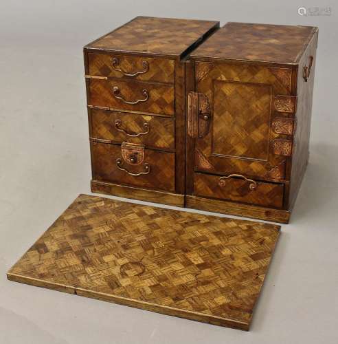 A JAPANESE PARQUETRY TABLE TOP CABINET, the removable top on...