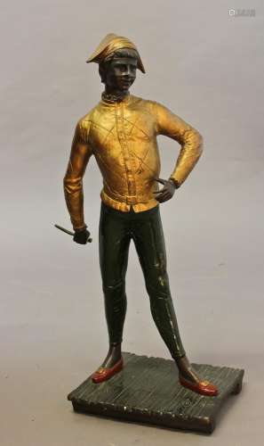 A COLD PAINTED FIGURE OF A HARLEQUIN, the young boy wearing ...