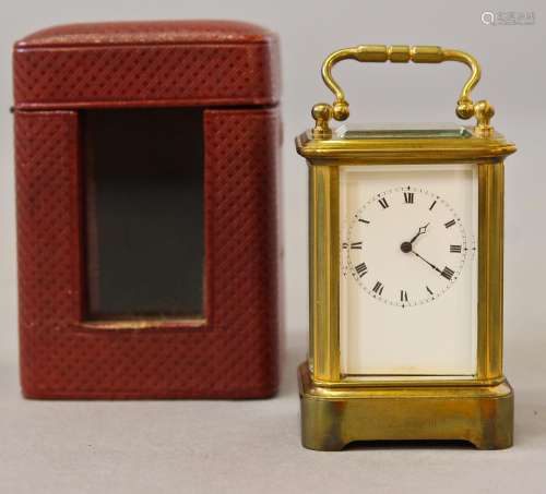 A MINIATURE CARRIAGE CLOCK, with white enamel dial with roma...