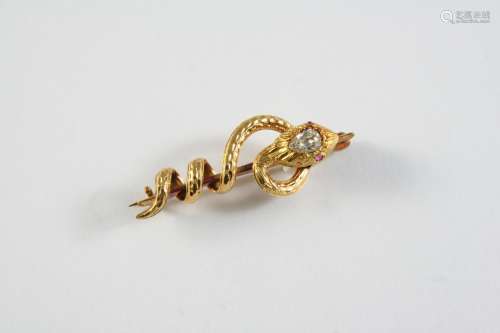 A GOLD AND DIAMOND SNAKE BROOCH the gold coiling snake has a...