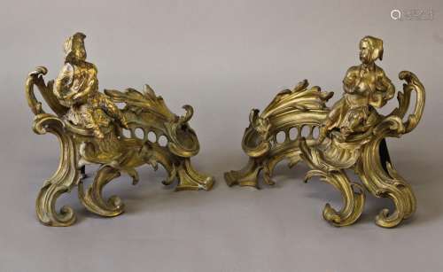 A PAIR OF ROCOCO STYLE GILT METAL CHENET, each decorated wit...