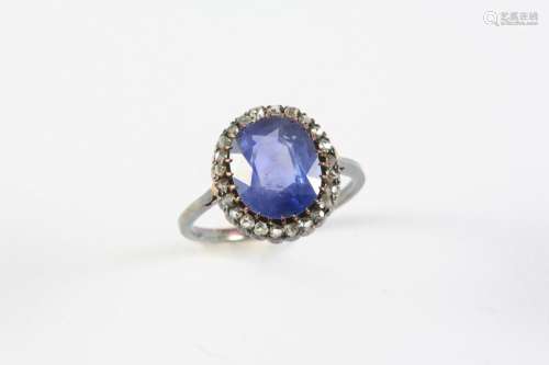 A SAPPHIRE AND DIAMOND CLUSTER RING the cushion-shaped sapph...