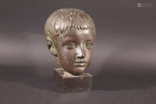 BUST OF A CHILD a bronze coated bust of a child, mounted on ...