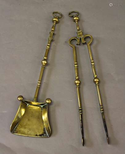 A PAIR OF 18TH CENTURY BRASS FIRE IRONS, the shovel with bro...