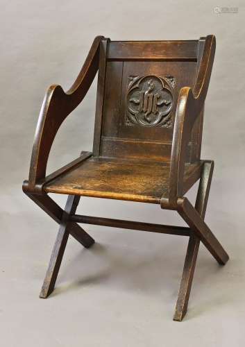 AN OAK GLASTONBURY STYLE ARM CHAIR, with solid seat and back...