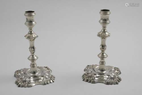 A PAIR OF EARLY GEORGE III CAST CANDLESTICKS on shaped squar...