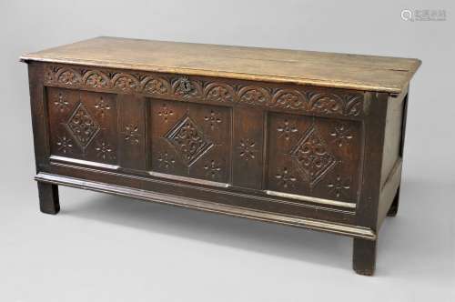 A 17TH CENTURY OAK COFFER, with a two plank top above a thre...
