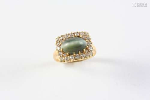 A CHRYSOBERYL CAT'S-EYE AND DIAMOND CLUSTER RING the oval-sh...