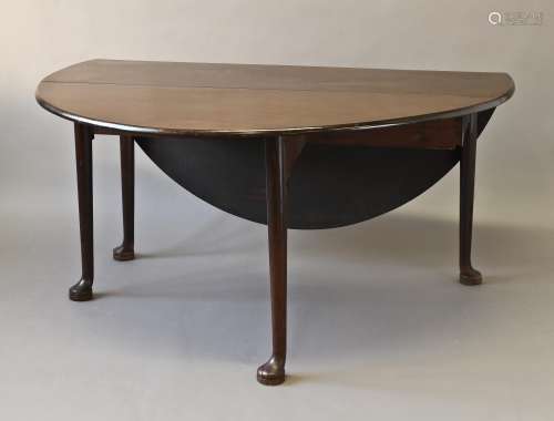 A GEORGE III MAHOGANY DROP FLAP DINING TABLE, the oval drop ...