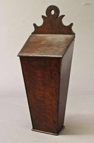 A GEORGE III OAK CANDLE BOX, of traditional form with scroll...