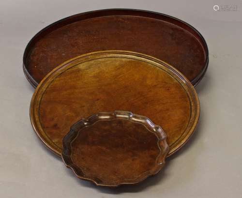 A GEORGE III STYLE MAHOGANY TRAY AND TWO OTHERS, A Chippenda...